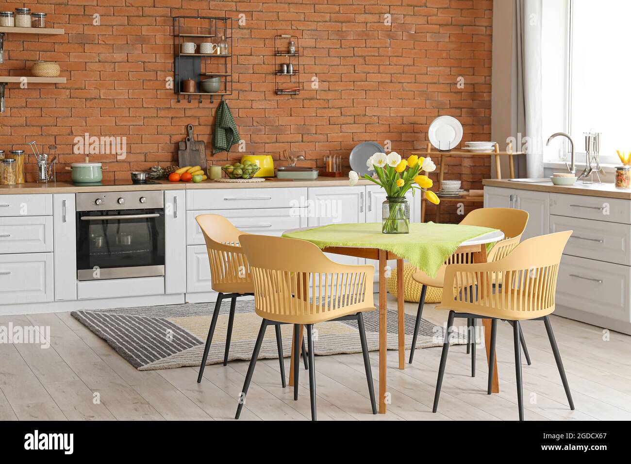 Interior of stylish kitchen with dining table Stock Photo - Alamy