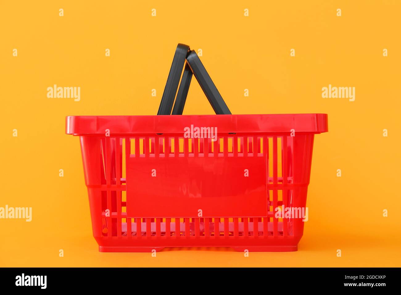 Shopping basket on color background Stock Photo - Alamy