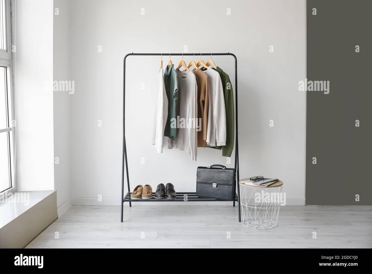 Rack with stylish clothes in room Stock Photo - Alamy