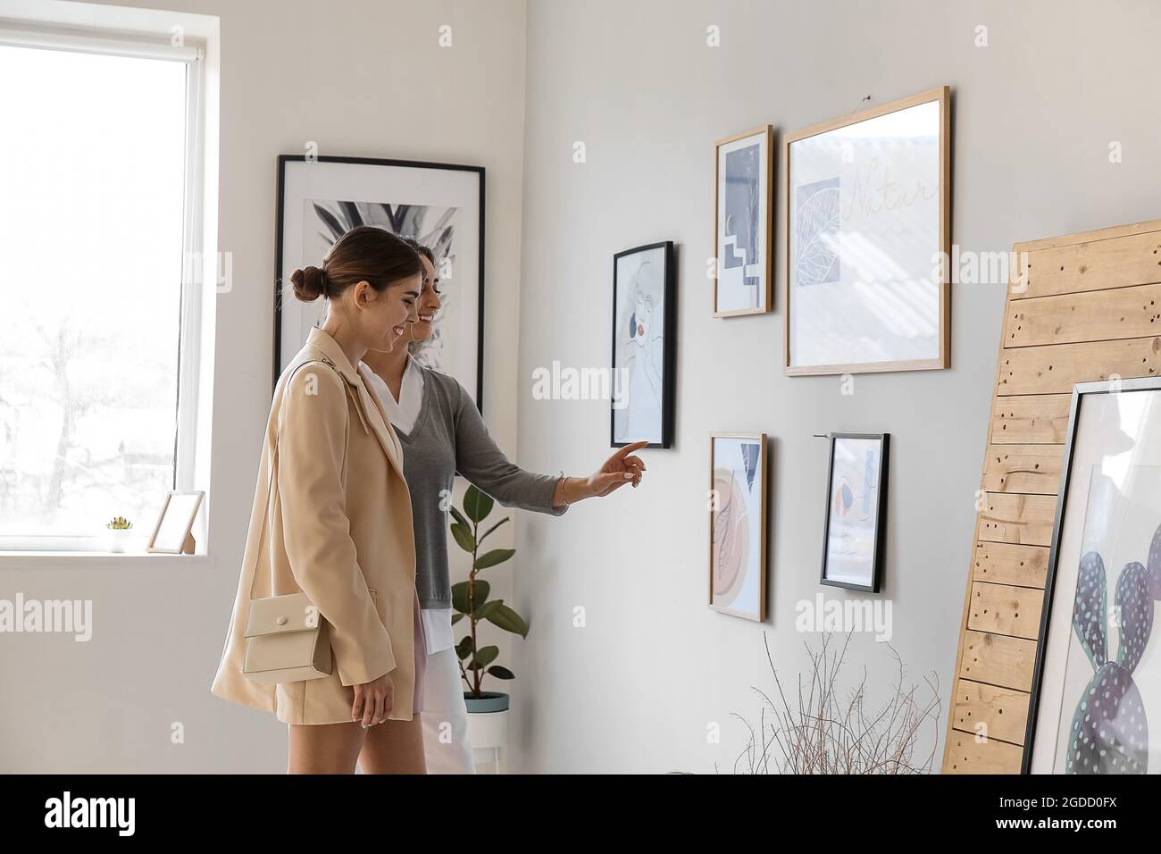 Women at exhibition in modern art gallery Stock Photo - Alamy