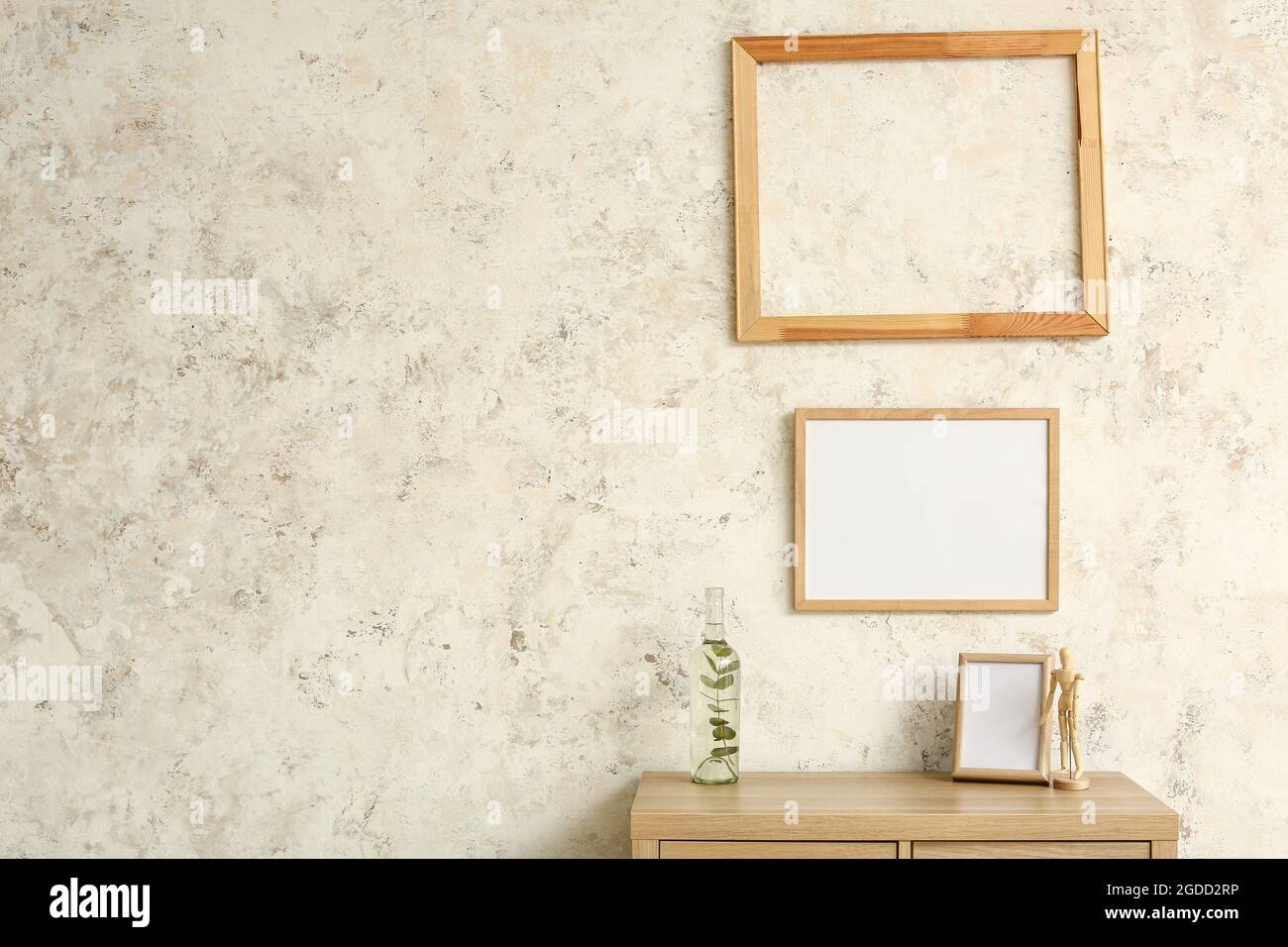 Wooden frames hanging on light wall Stock Photo - Alamy