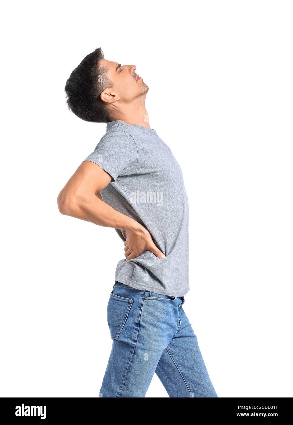 Young man suffering from back pain on white background Stock Photo - Alamy