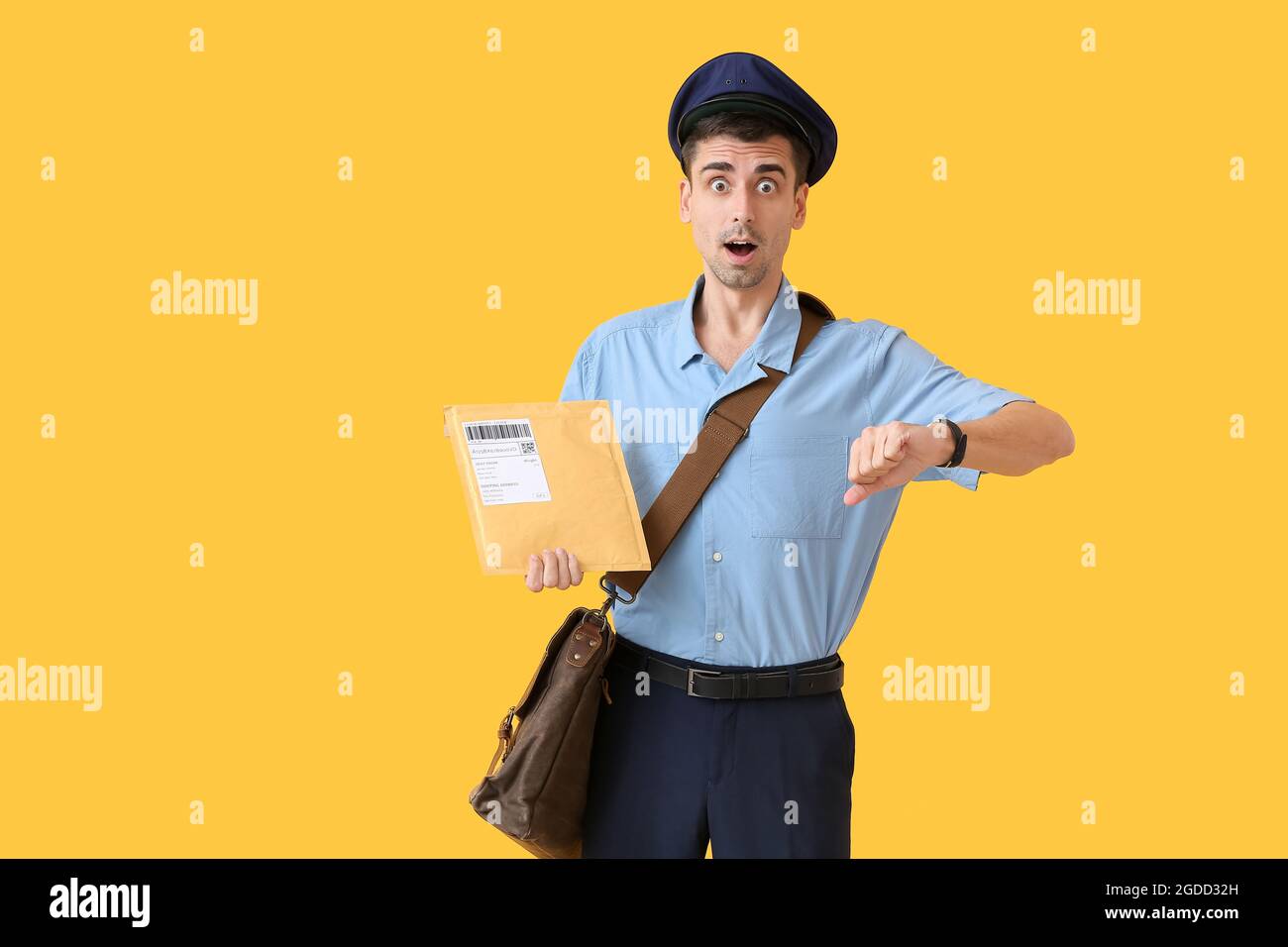 Shocked young postman on color background Stock Photo - Alamy