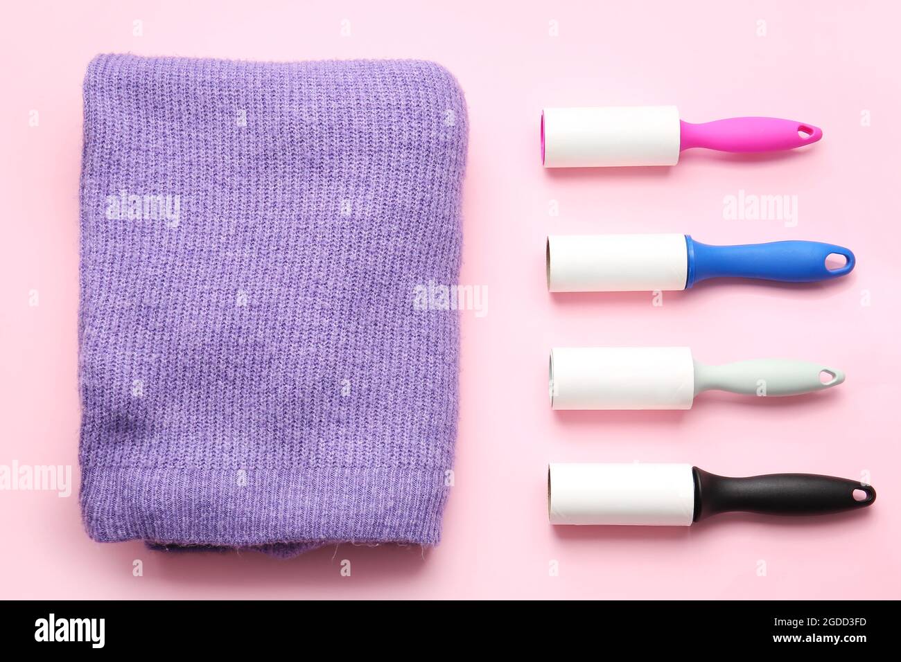 Lint rollers and clothes on color background Stock Photo Alamy