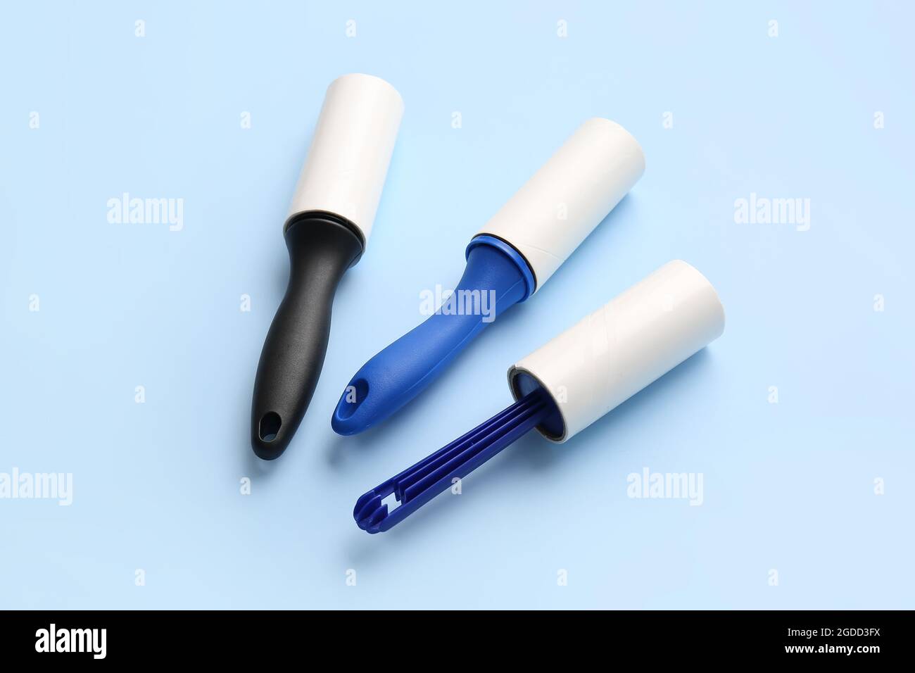 Different lint rollers on color background Stock Photo