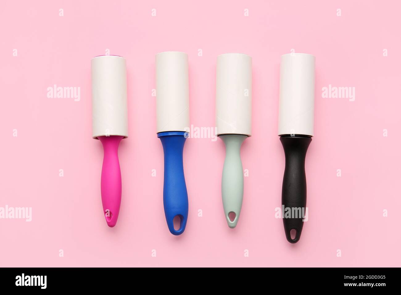 Different lint rollers on color background Stock Photo