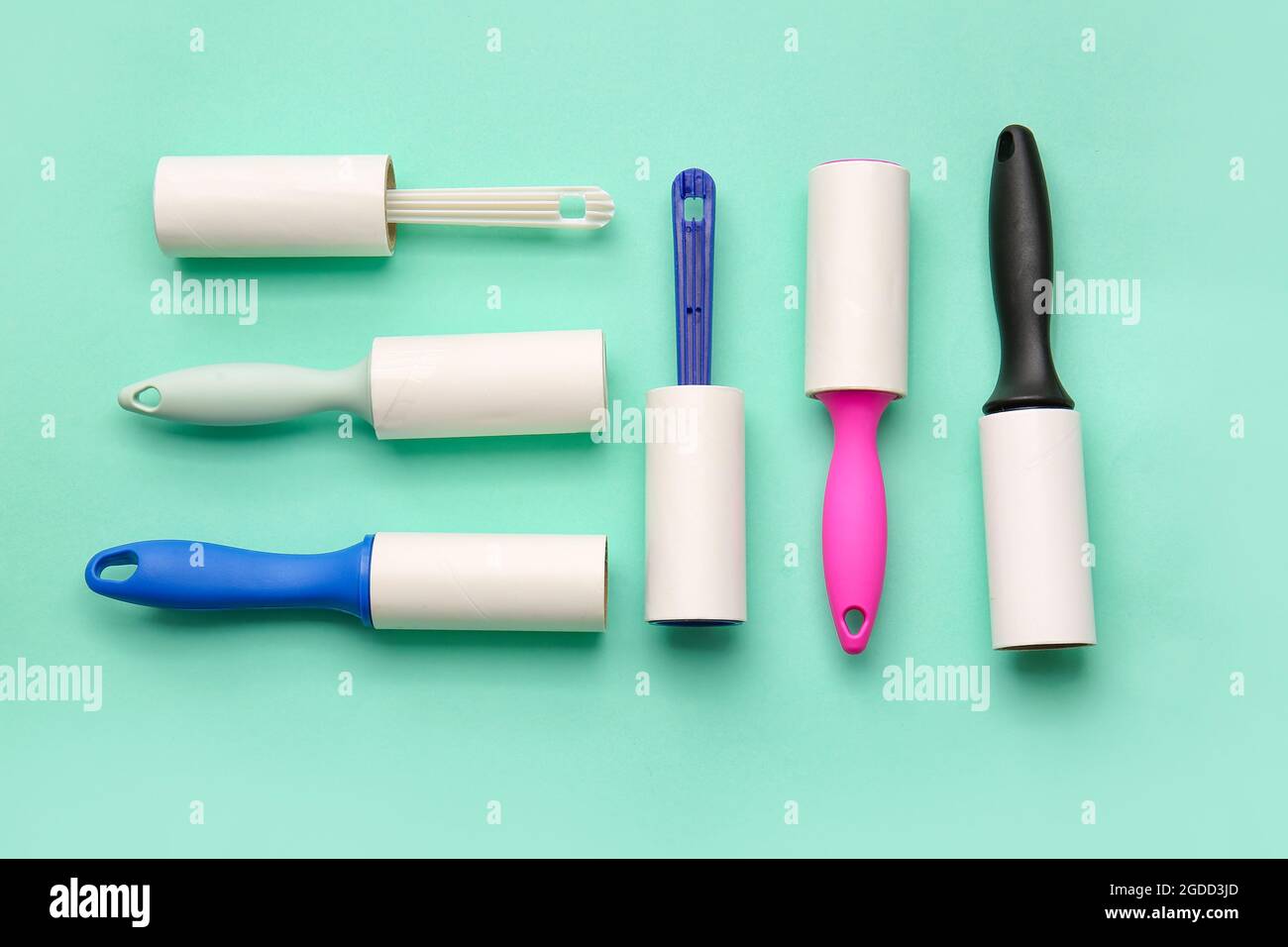 Different lint rollers on color background Stock Photo