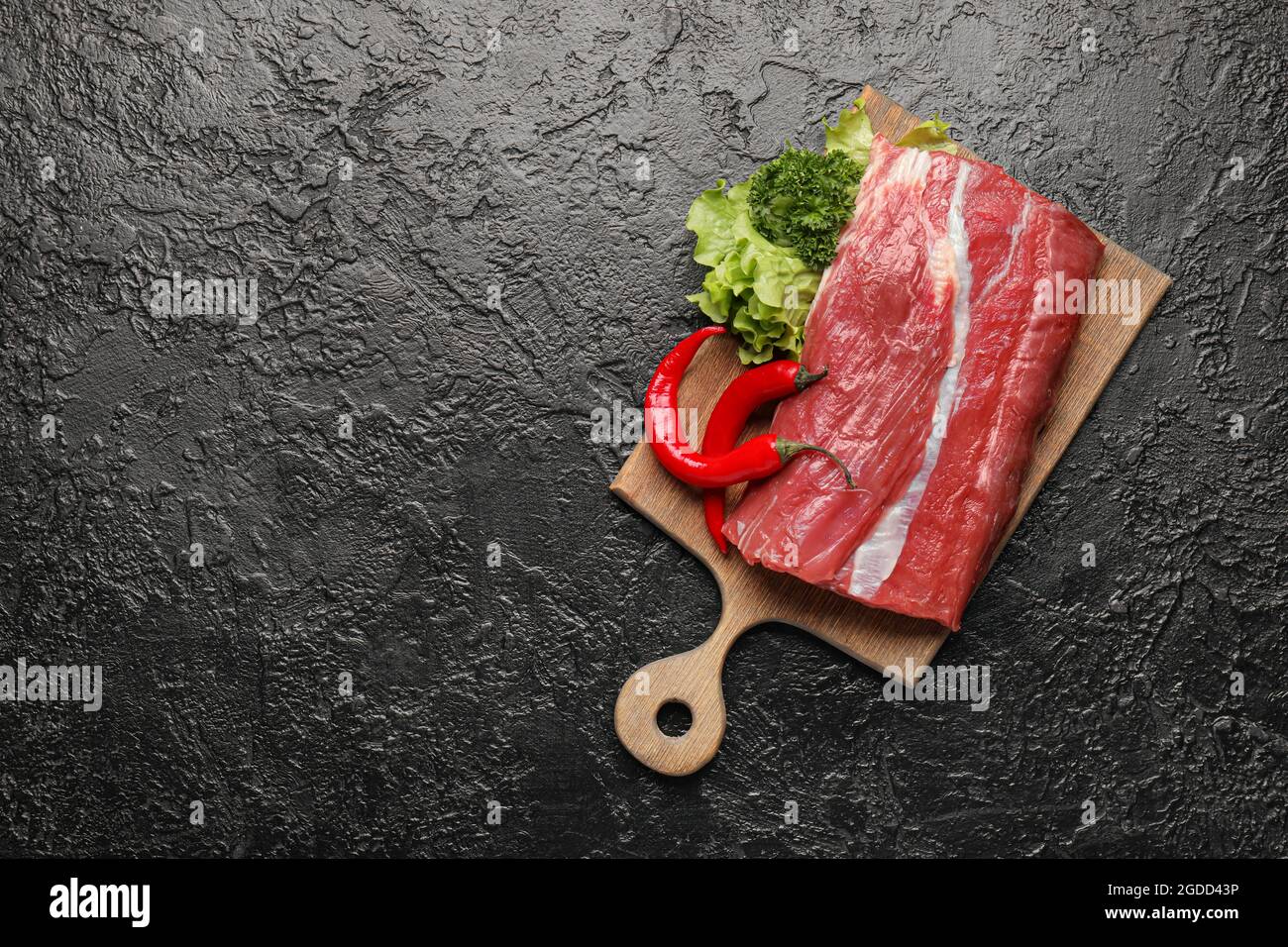 Wooden board with raw beef brisket on dark background Stock Photo - Alamy