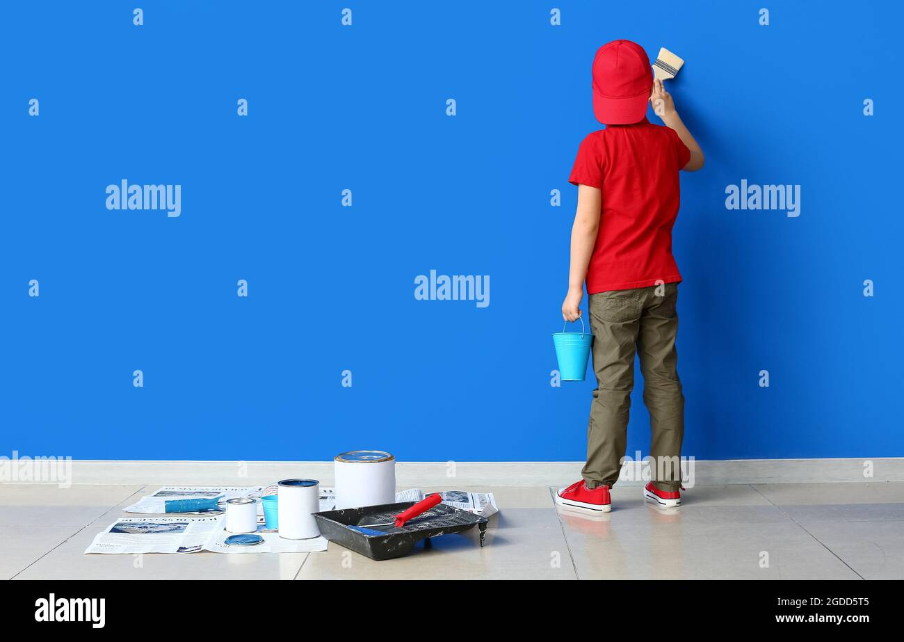 Little boy painting wall in room Stock Photo Alamy