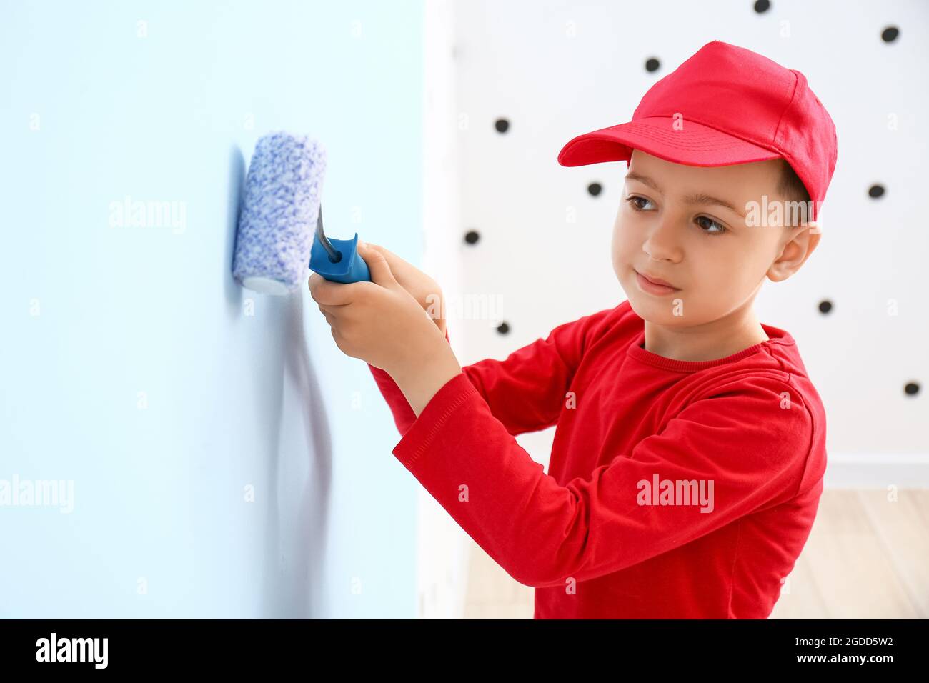 Little boy painting wall in room Stock Photo Alamy