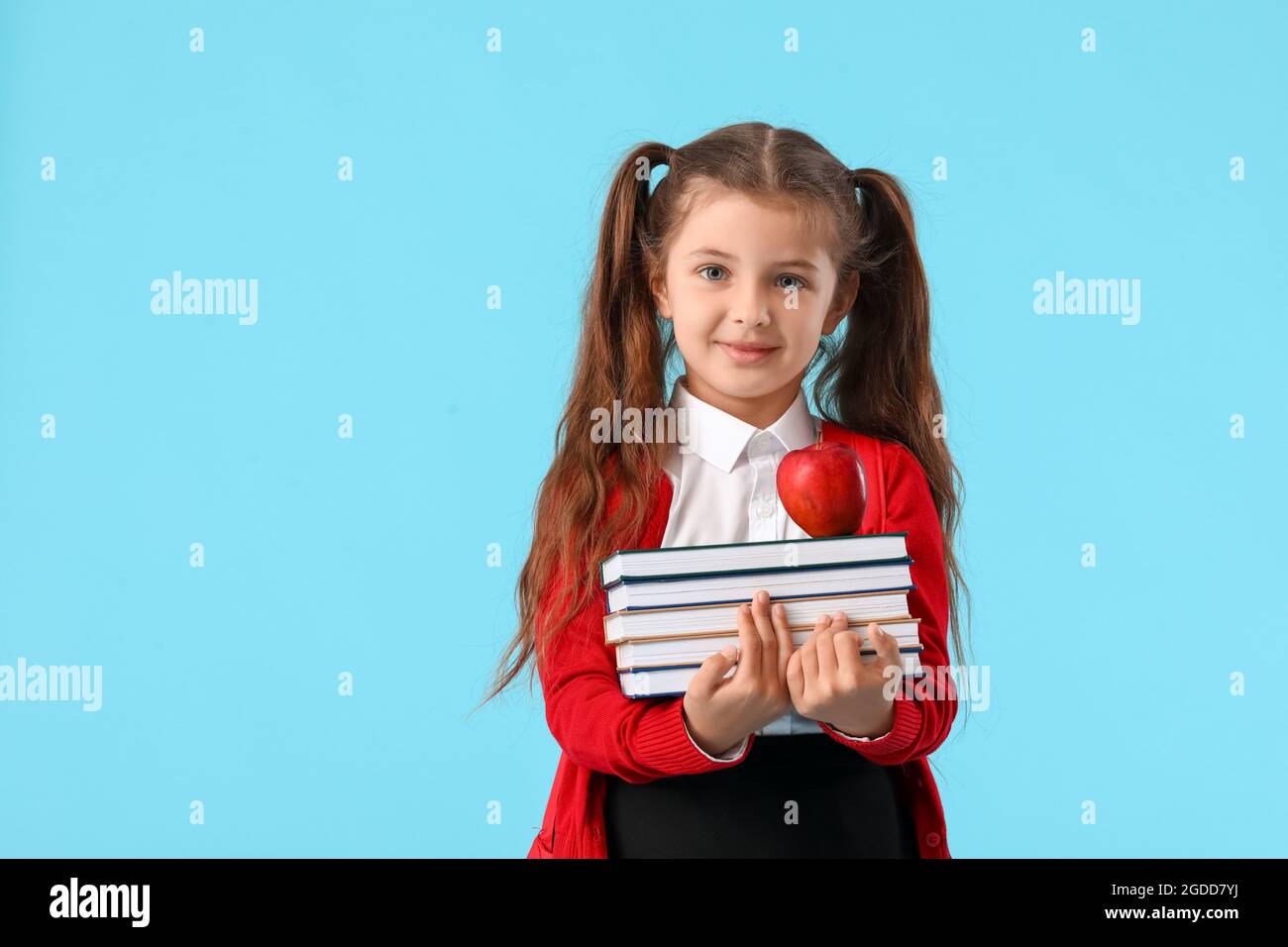 Cute little school girl with books on color background Stock Photo - Alamy
