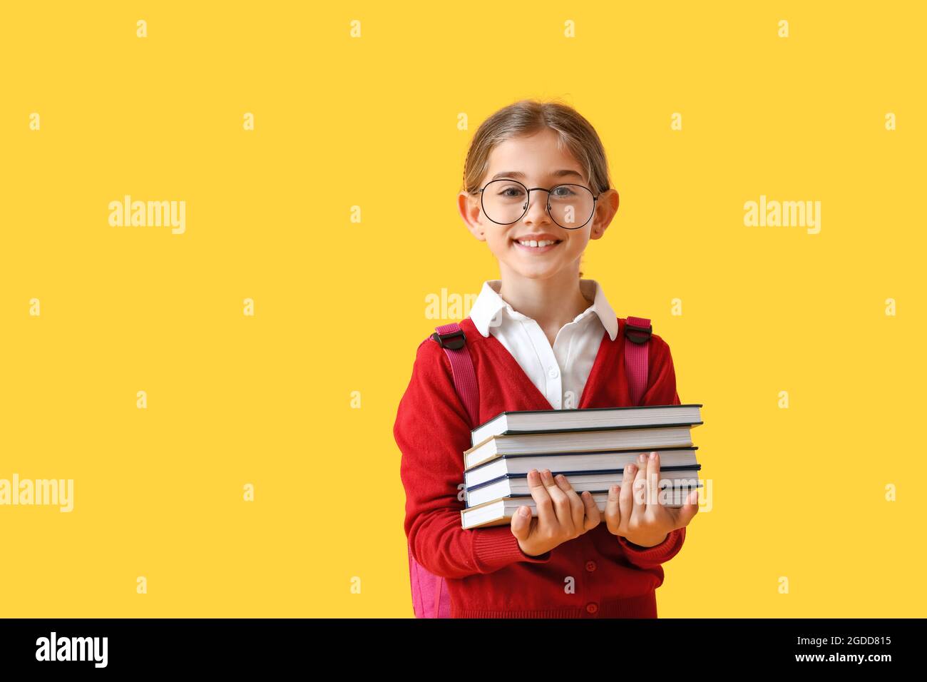 Cute little school girl with books on color background Stock Photo - Alamy