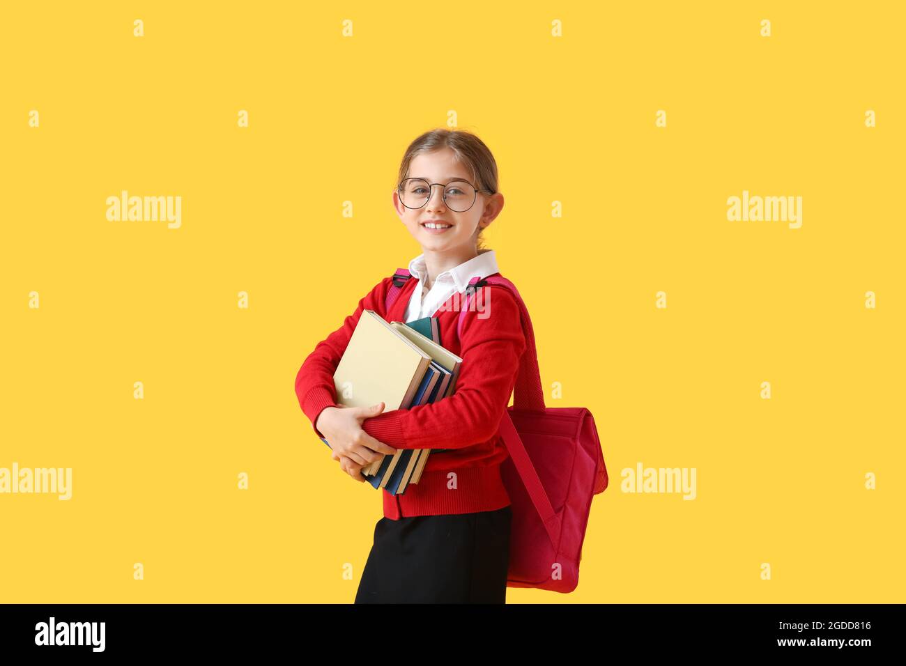 Cute little school girl with books on color background Stock Photo - Alamy