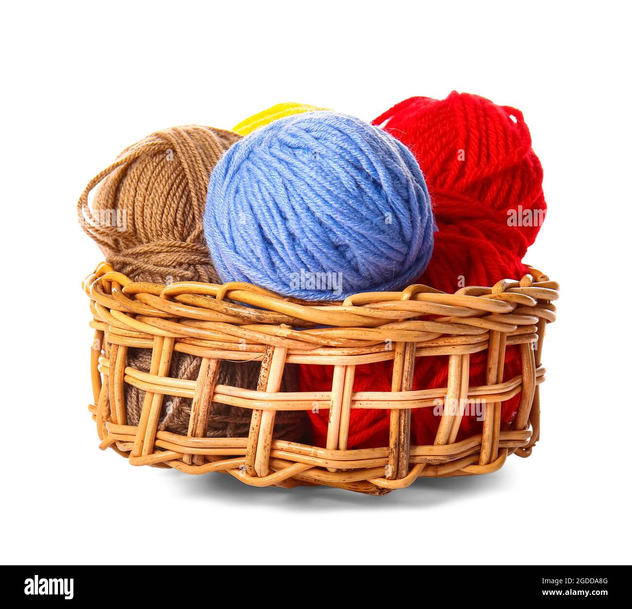 Wicker basket with knitting yarn on white background Stock Photo - Alamy