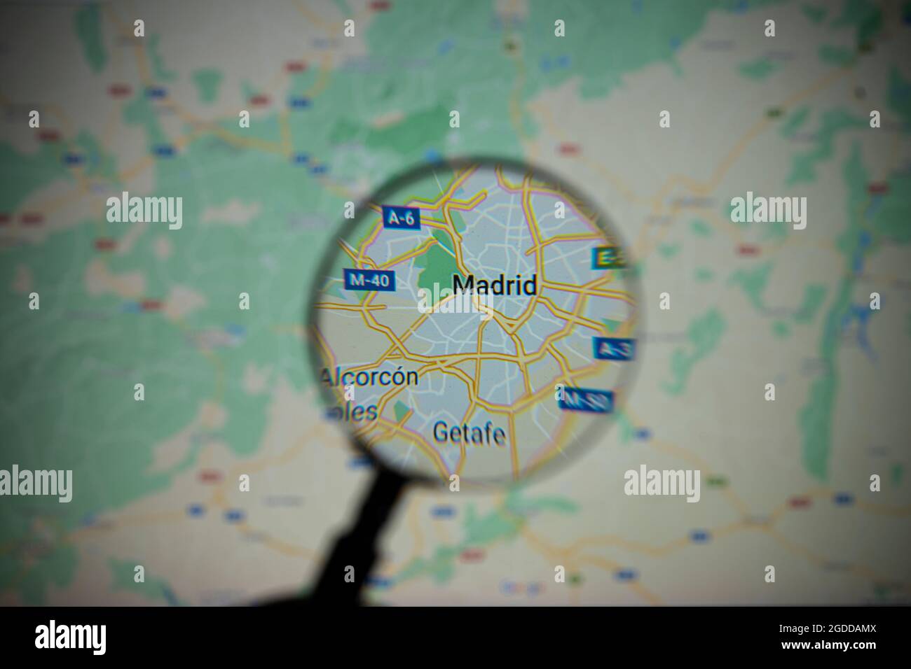 view of the city of Madrid, capital of Spain, through a magnifying glass on Google Maps Stock Photo