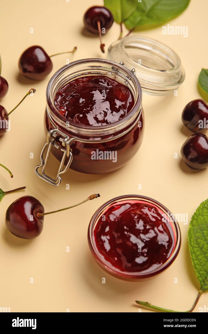 Composition with tasty cherry jam on color background Stock Photo - Alamy