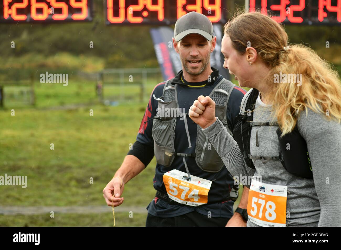 REEFTON, NEW ZEALAND, AUGUST 7, 2021; Competitor Colette Humphries (right) and Robert Holder celebrate their  completion of the 10km section of the Re Stock Photo