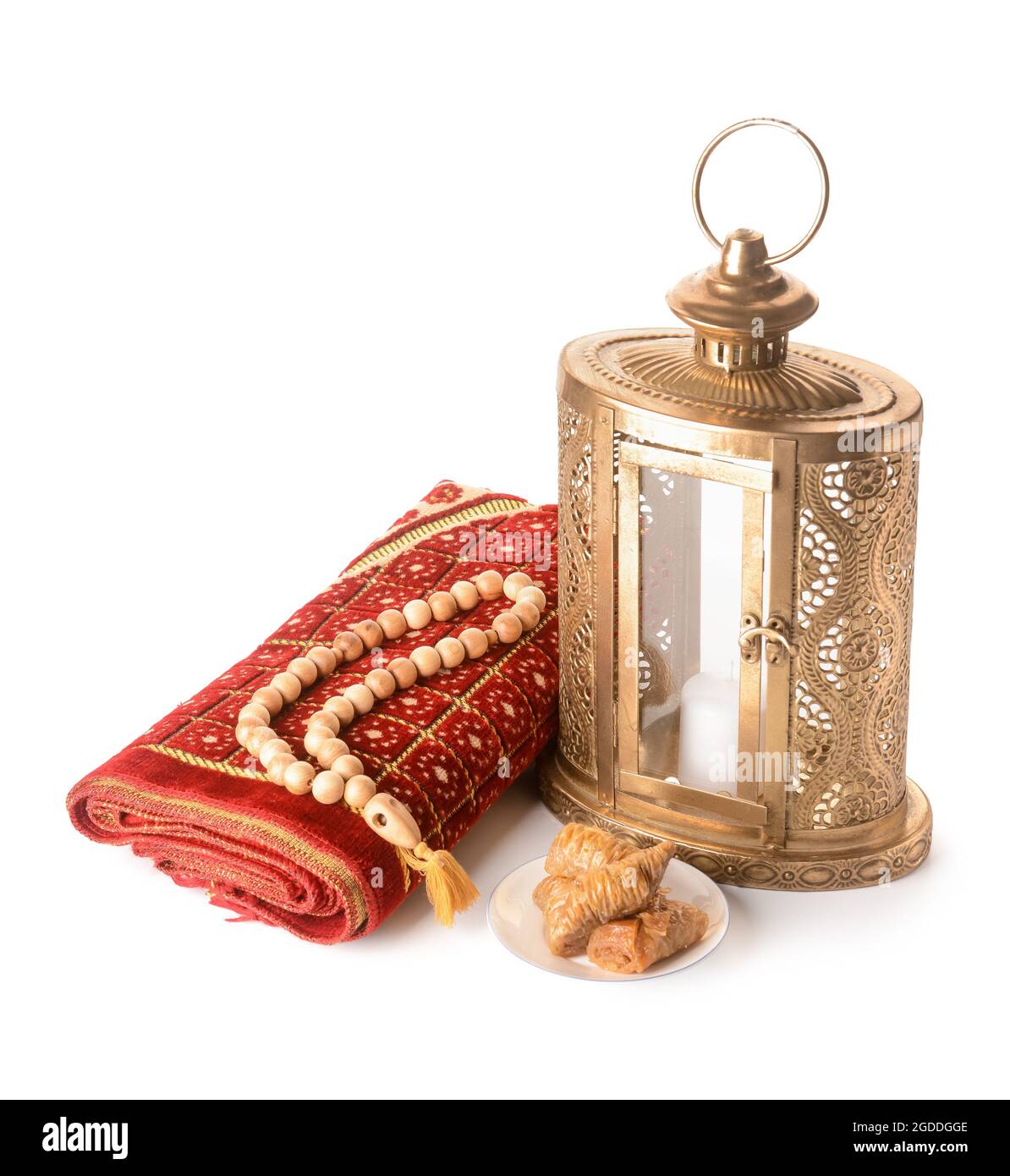 Muslim lantern with prayer rug, tasbih and Turkish sweets on white background Stock Photo