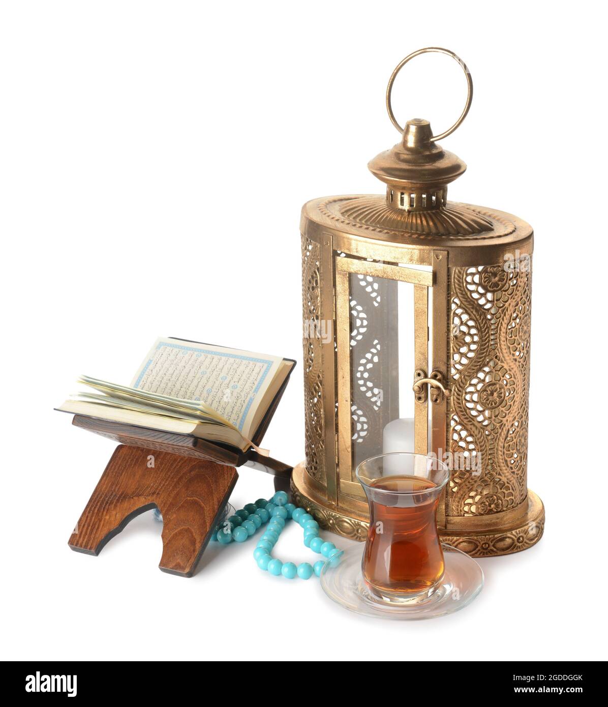 Muslim lantern with Quran, tasbih and Turkish tea on white background Stock Photo