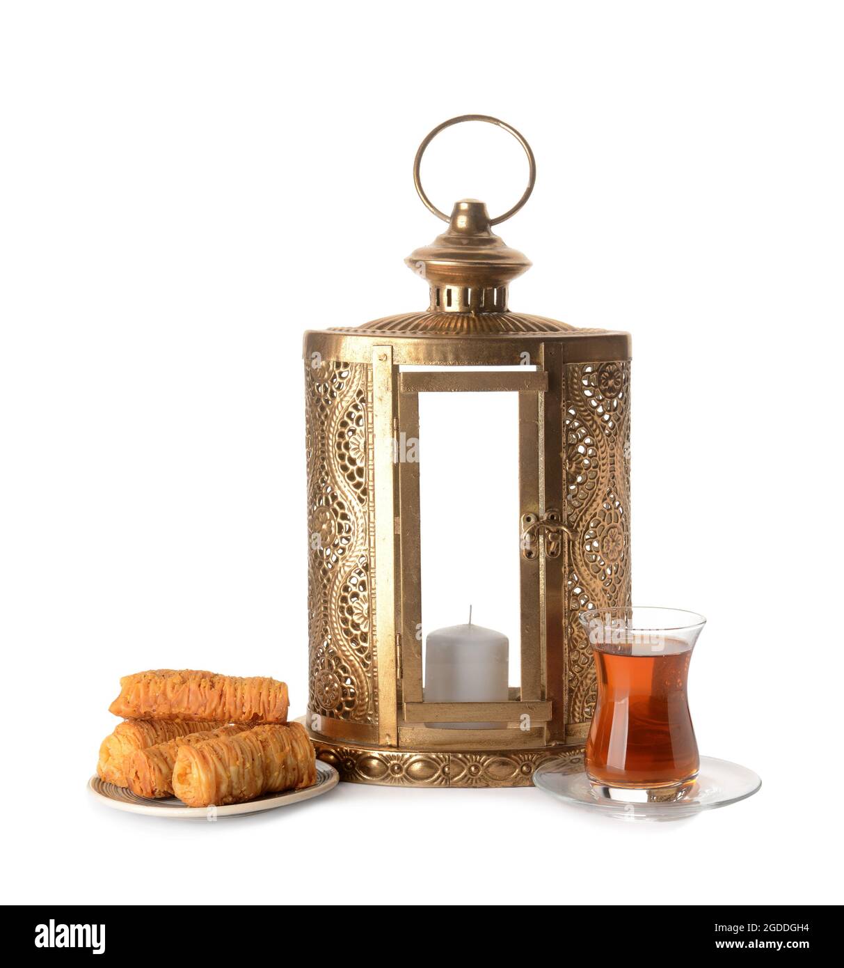 Muslim lantern with Turkish sweets and tea on white background Stock Photo