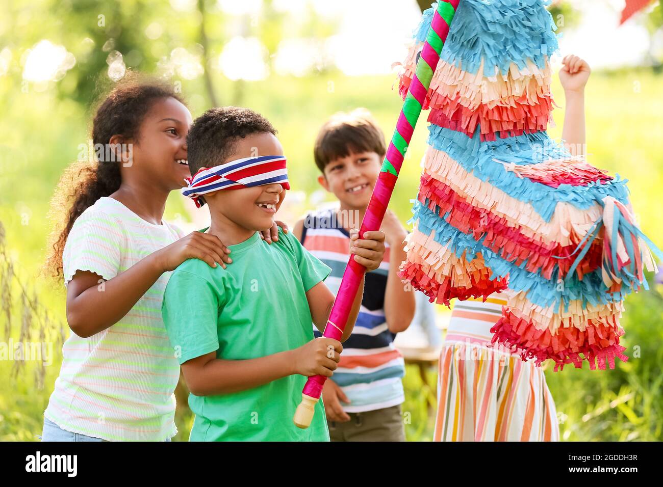 Cute children at pinata birthday party Stock Photo - Alamy