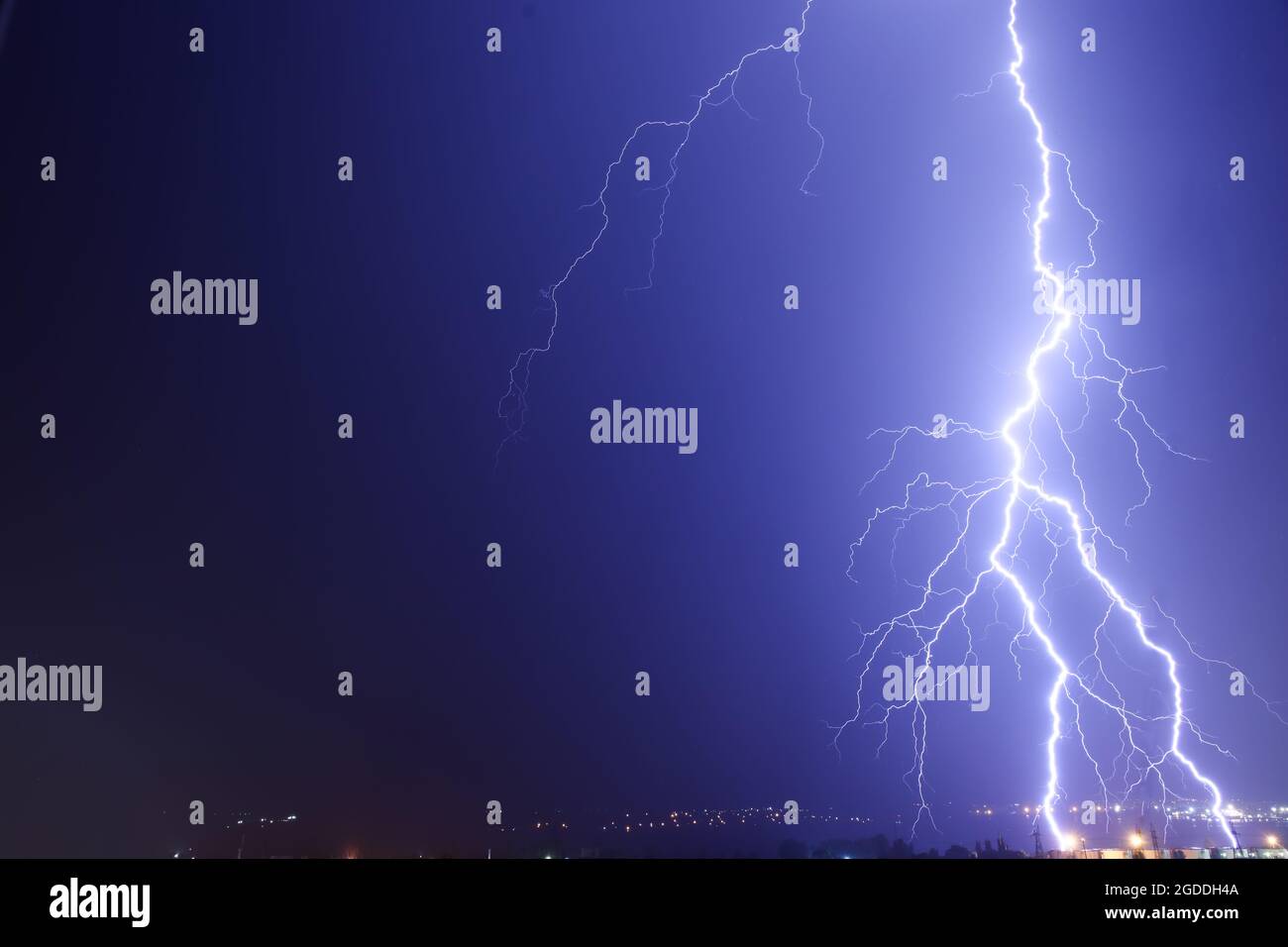 Dark sky with lightning over night city Stock Photo - Alamy