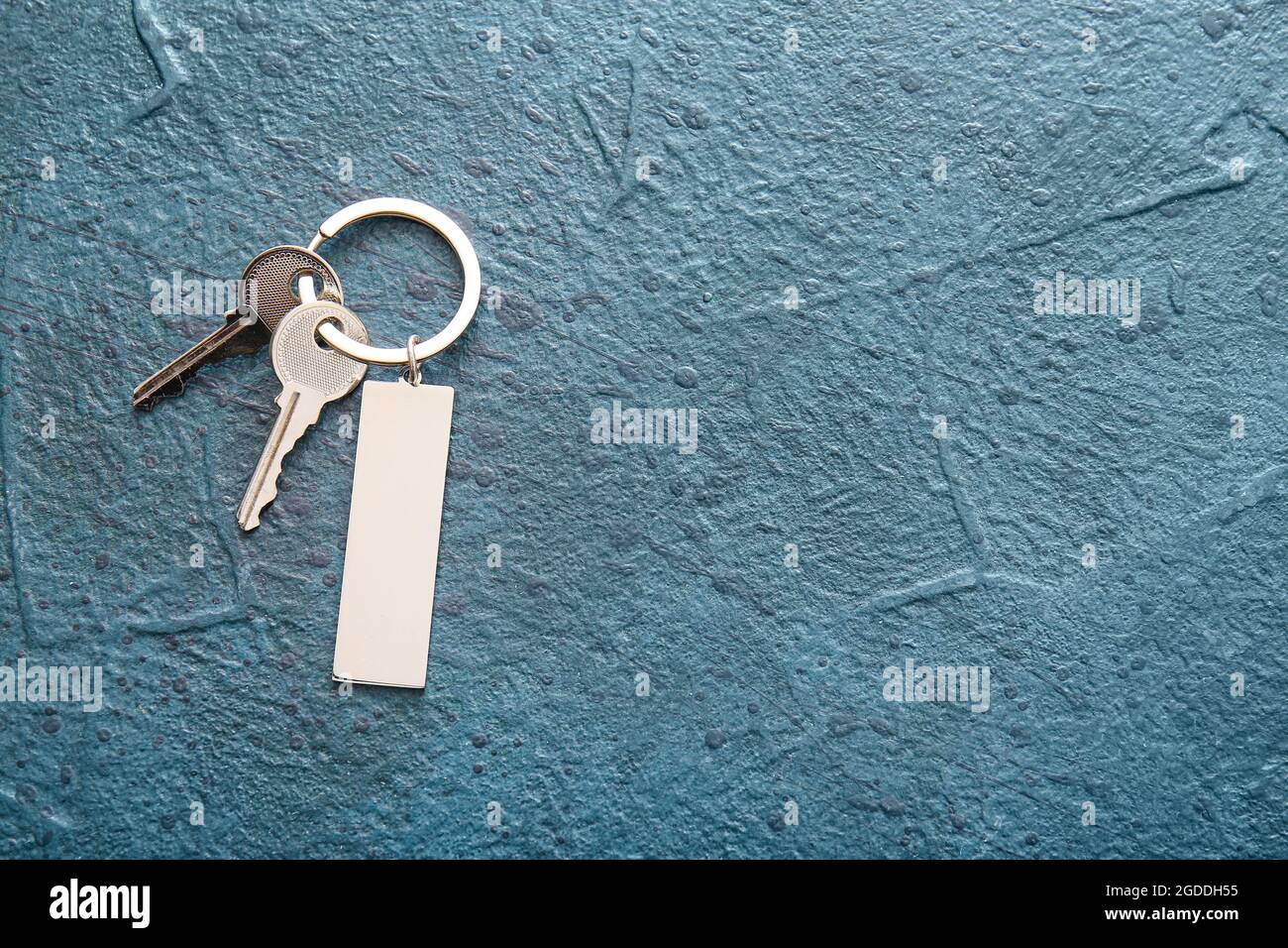 Keys with stylish keychain on dark background Stock Photo