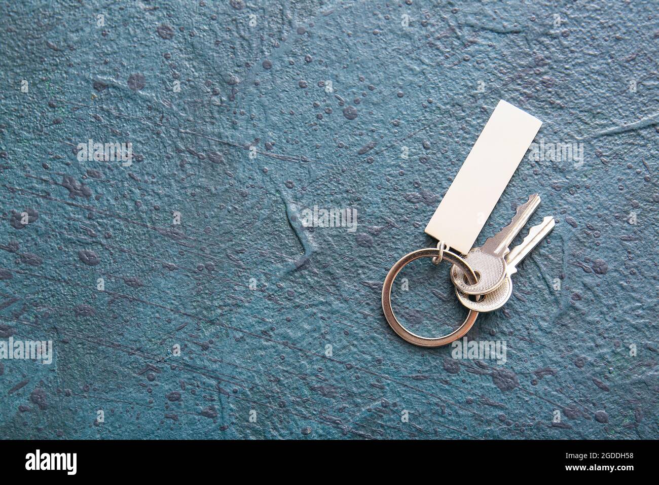 Keys with stylish keychain on dark background Stock Photo