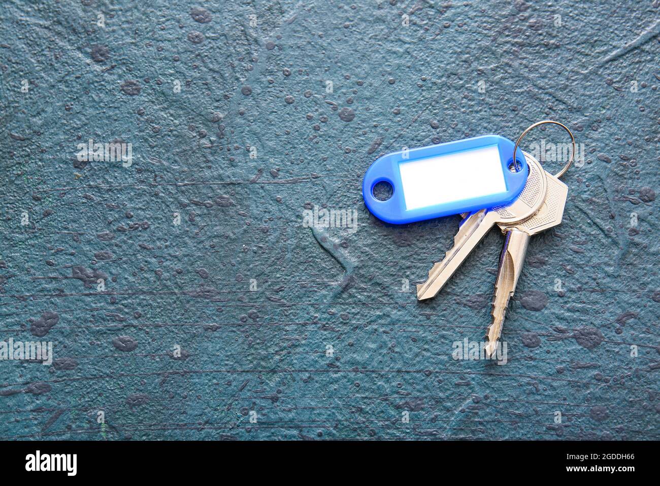 Plastic tag with keys on dark background Stock Photo