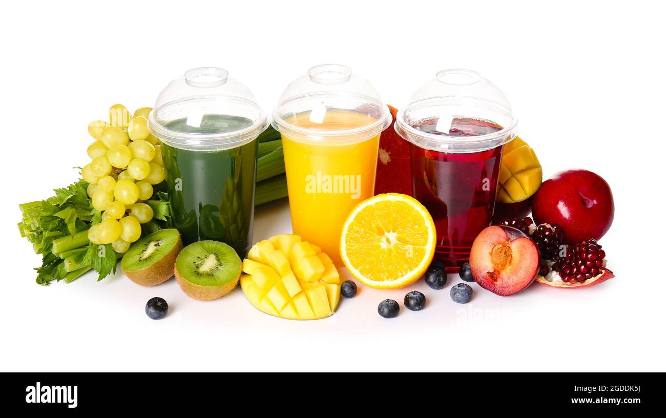 Plastic cups with healthy juice, fruits and vegetables on white — free download