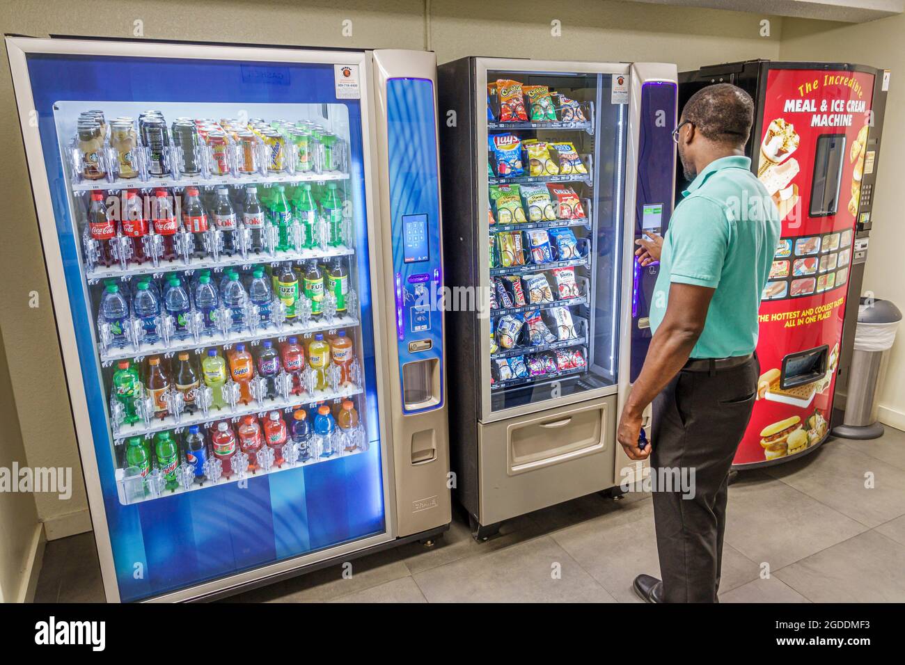 Miami Florida,Black man men male deciding choosing,vending machine machines soft drink drinks soda sodas,snacks, Stock Photo