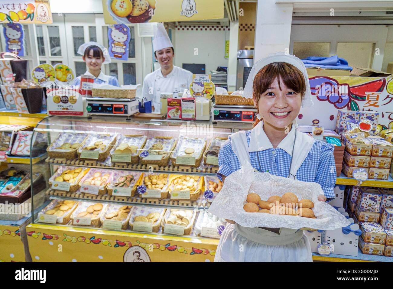 Tokyo Japan,JR Ikebukuro Station,bakery display case offers offering free sample samples Asians,Oriental woman women female employee worker smiling Ja Stock Photo
