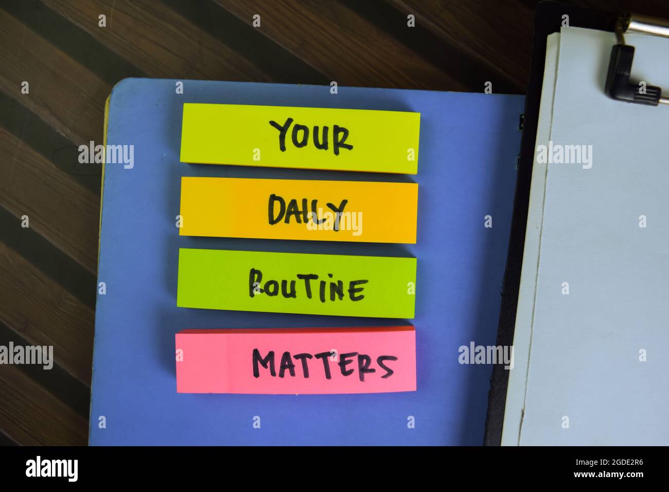 Your Daily Routine Matters write on sticky notes isolated on Wooden ...