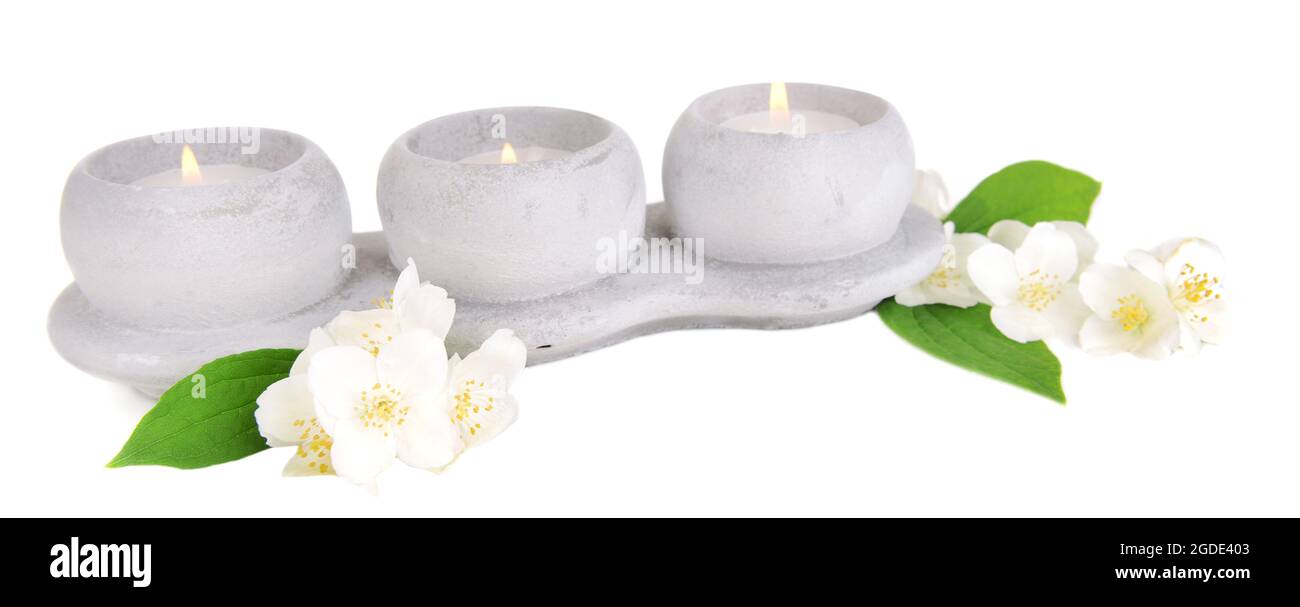 Candles with jasmine flowers isolated on white Stock Photo Alamy