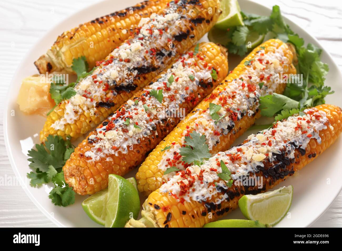 Elote, Grilled Mexican Street Corn, charred cobs are slathered in