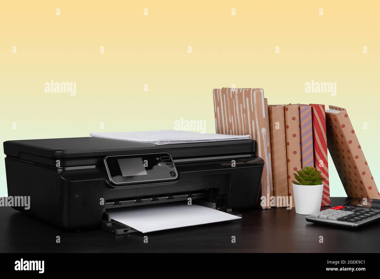 Compact home laser printer against yellow background Stock Photo