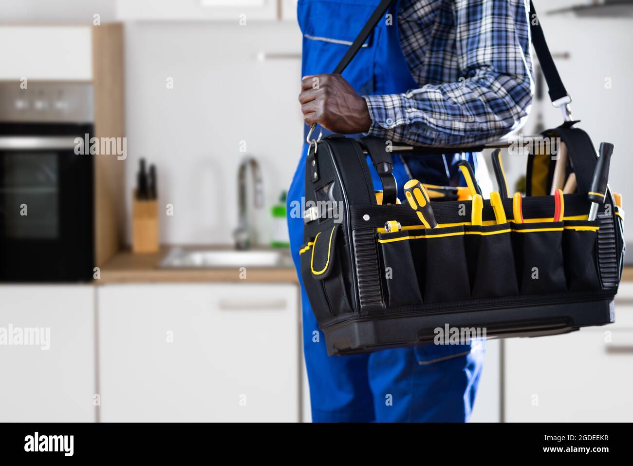 African American Handyman With Repair Box Or Toolbox Stock Photo