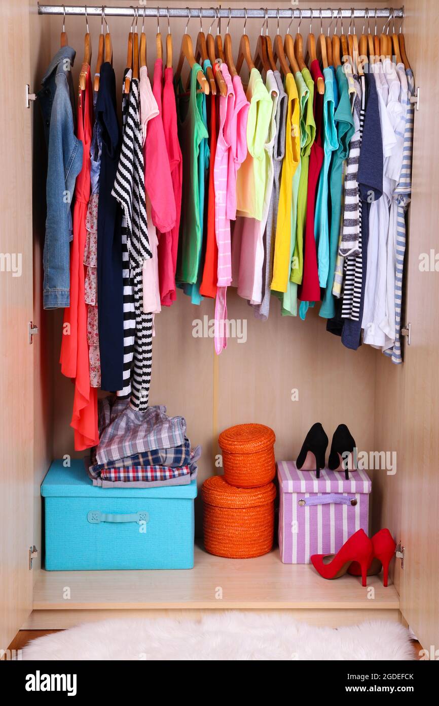 Colorful clothes hanging in wardrobe Stock Photo Alamy