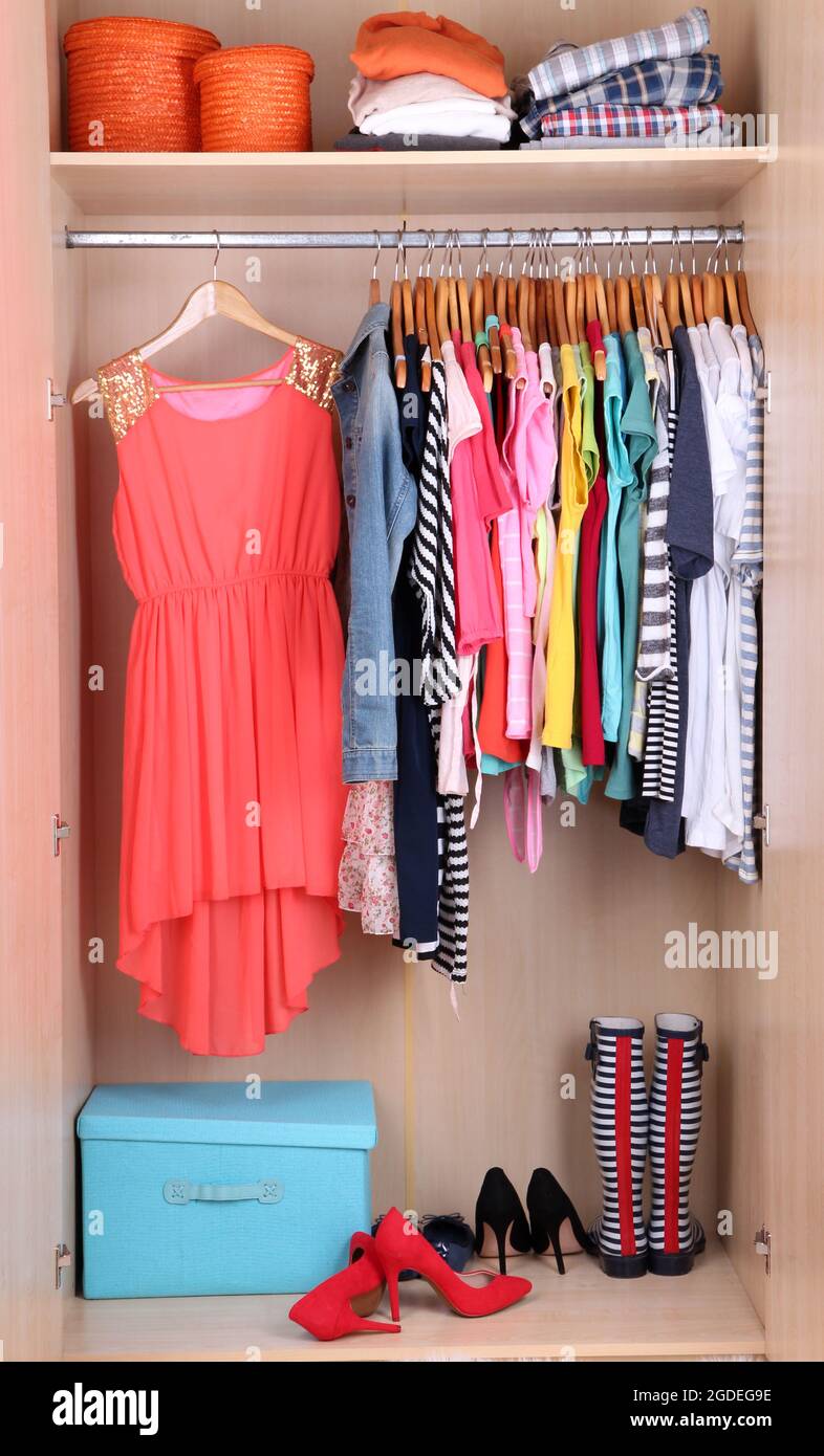 Colorful clothes hanging in wardrobe Stock Photo Alamy