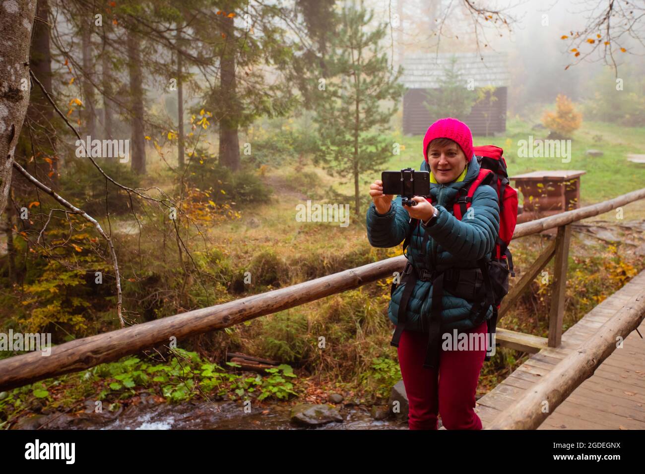 Woman is taking a selfie while hiking in the forest Stock Photo - Alamy
