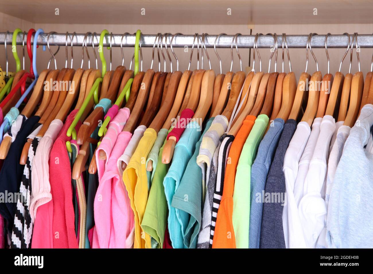 Colorful clothes hanging in wardrobe Stock Photo Alamy