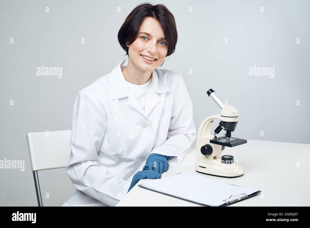 female laboratory assistant in white coat research science biology ...