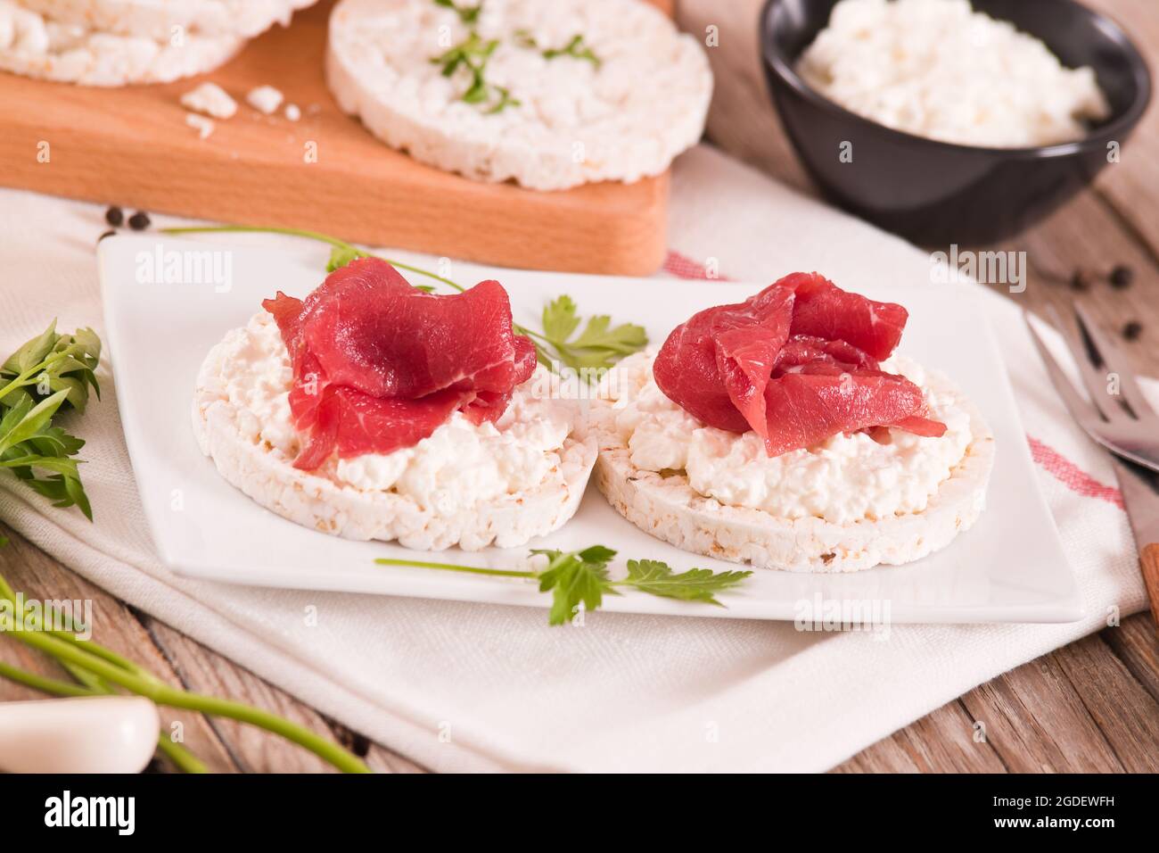 Rice cakes with milk flakes and cold beef Stock Photo - Alamy