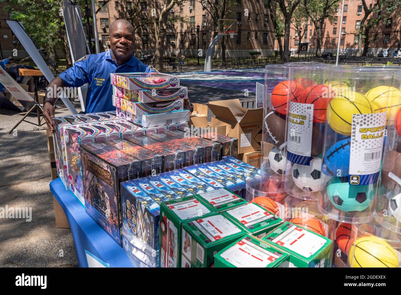Officer Python's Basketball NYPD Officer Lubin places toys for kids on a table at a Queensbridge ...