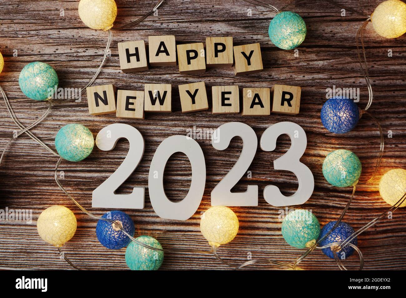 Happy New Year 2023 decorate with LED cotton ball on wooden ...