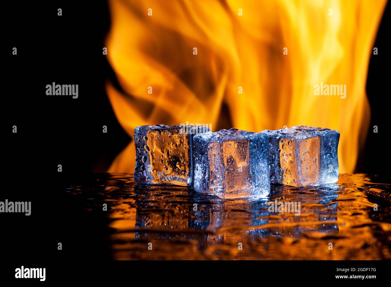 three ice cubes against the background of fire, fire and ice, place under  the text Stock Photo - Alamy