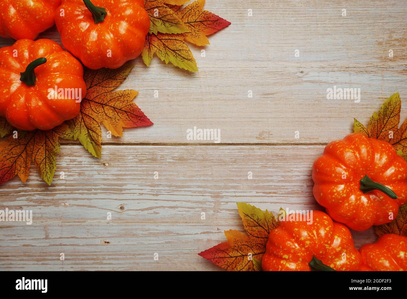 Pumpkin and Autumn leaves with space copy on wooden background Stock ...