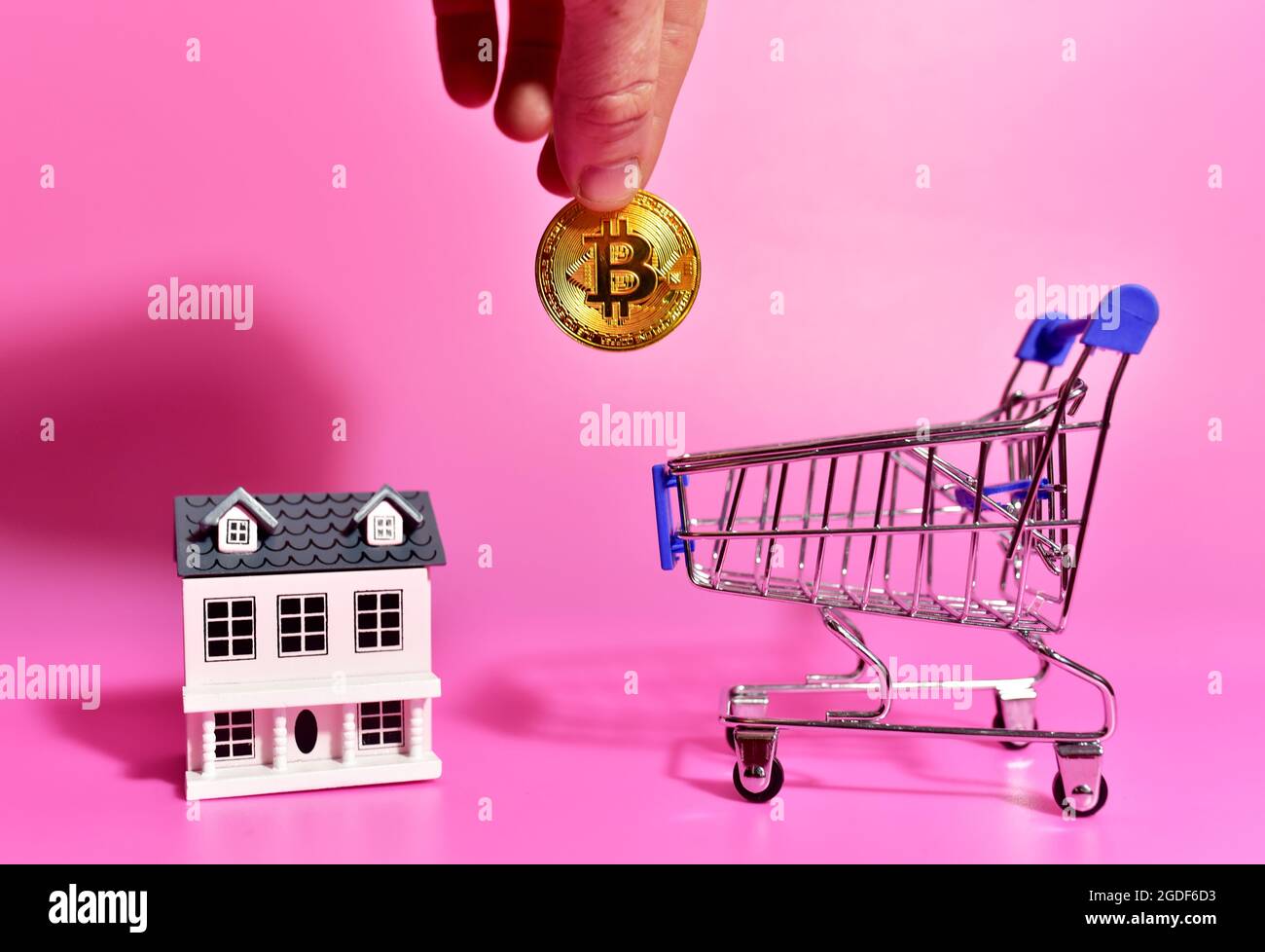 Purchasing property with Bitcoin Payments. Concept of buying real estate  and housing for cryptocurrency. BTC crypto coin and miniature house on blue  b Stock Photo - Alamy