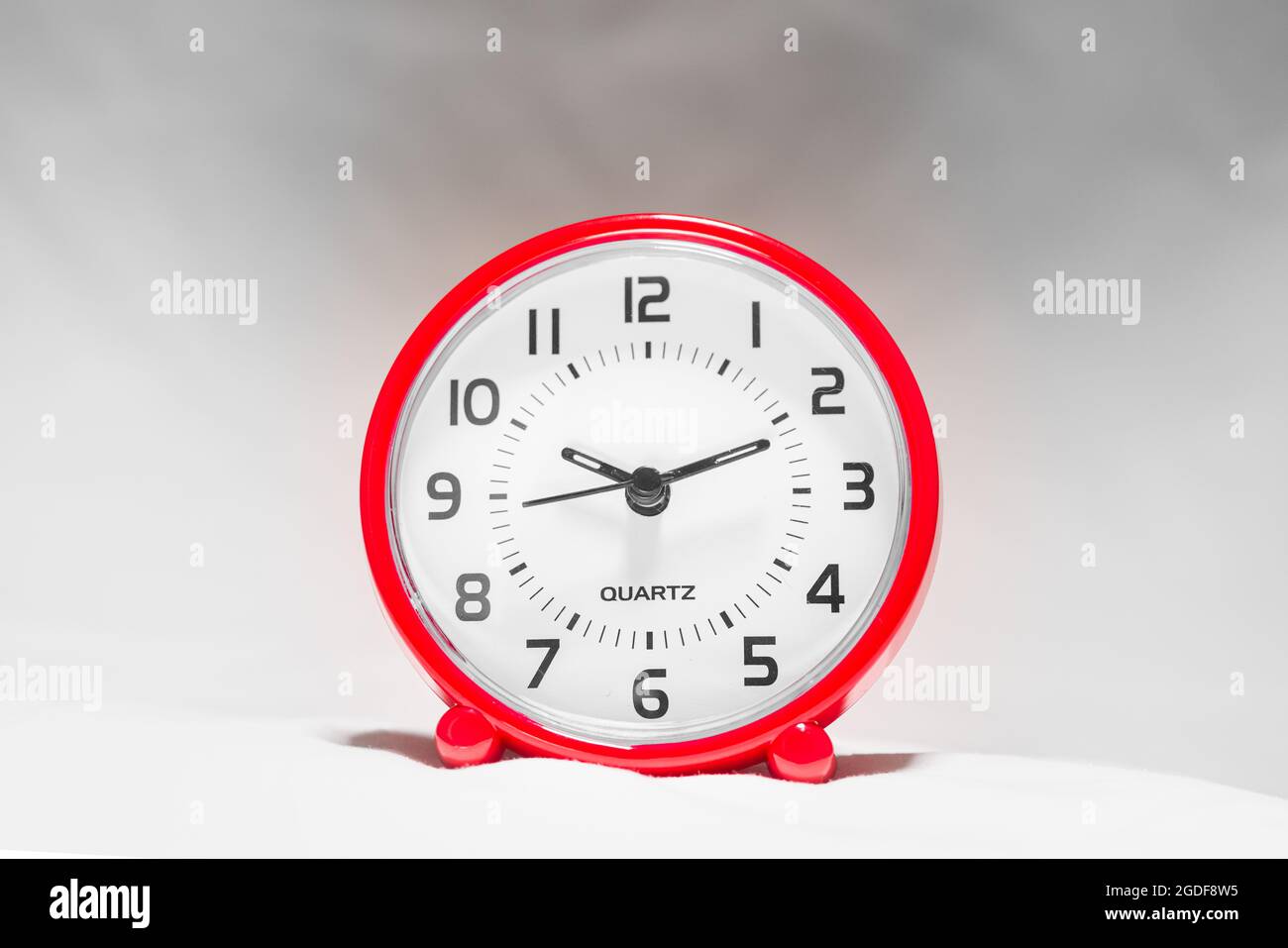 https://c8.alamy.com/comp/2GDF8W5/small-red-alarm-clock-show-the-running-time-a-modern-clock-with-red-frame-smile-face-of-a-clock-close-up-on-a-red-plastic-watch-with-second-pointer-2GDF8W5.jpg