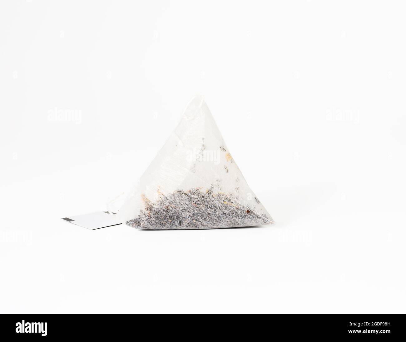 triangular disposable tea bag on a rope, white background Stock Photo